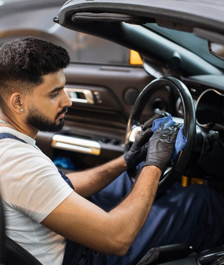 Technician detailing a car interior
